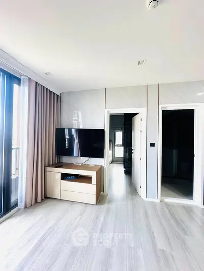 Modern living room with sleek TV setup and elegant flooring