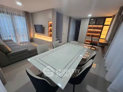 Modern living room with elegant dining area and stylish furniture