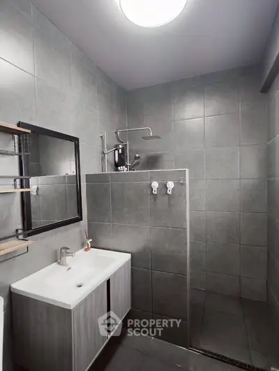 Modern bathroom with sleek gray tiles and contemporary fixtures