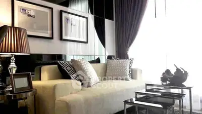 Elegant living room with modern decor, plush sofa, and stylish lighting in a luxurious apartment.