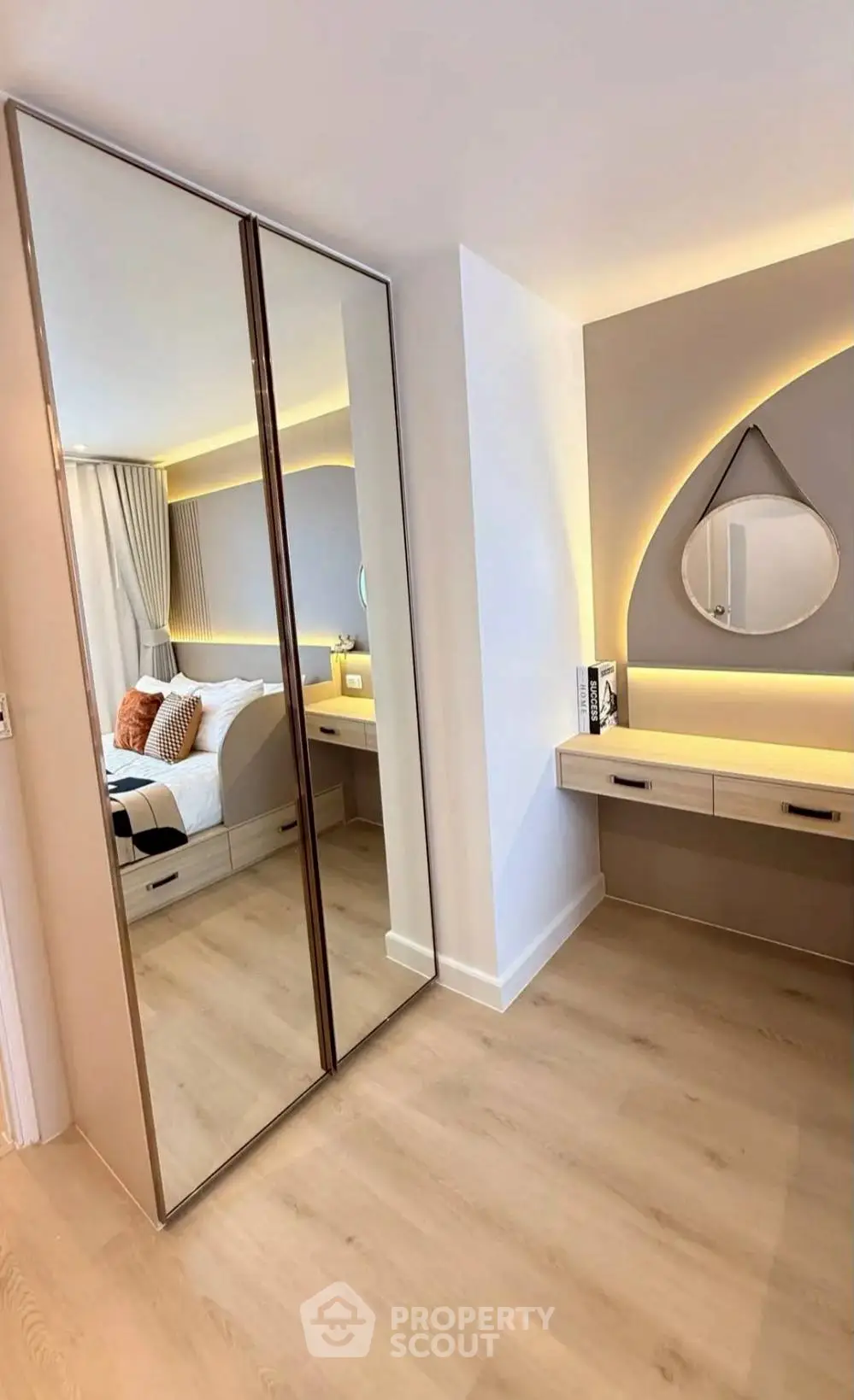 Modern bedroom with mirrored wardrobe and stylish vanity area