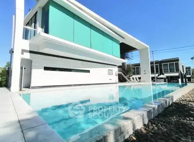 Modern luxury home with sleek architecture and stunning poolside view.