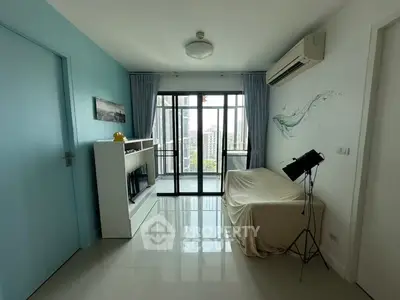 Bright room with large windows and balcony view, featuring modern decor and air conditioning.