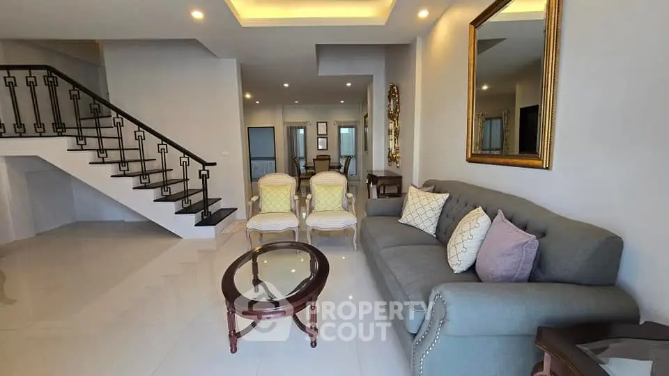Spacious modern living room with elegant staircase and stylish furniture