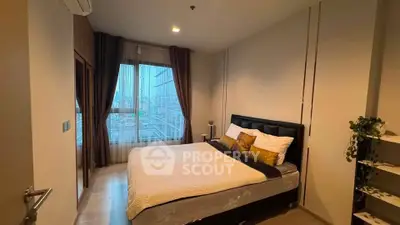 Modern bedroom with city view, featuring cozy bed and stylish decor in high-rise apartment.