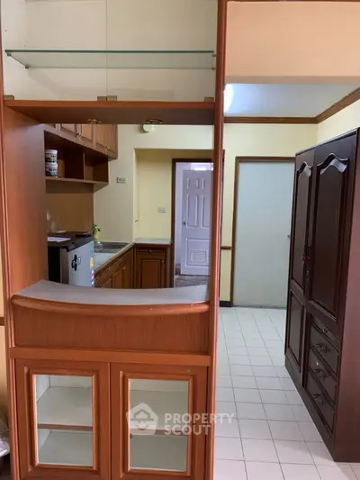 Cozy kitchen with wooden cabinetry and compact design, perfect for efficient cooking and storage.
