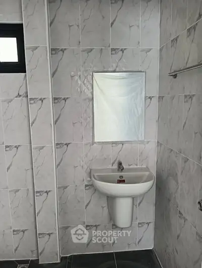 Modern bathroom with sleek sink and marble tiles