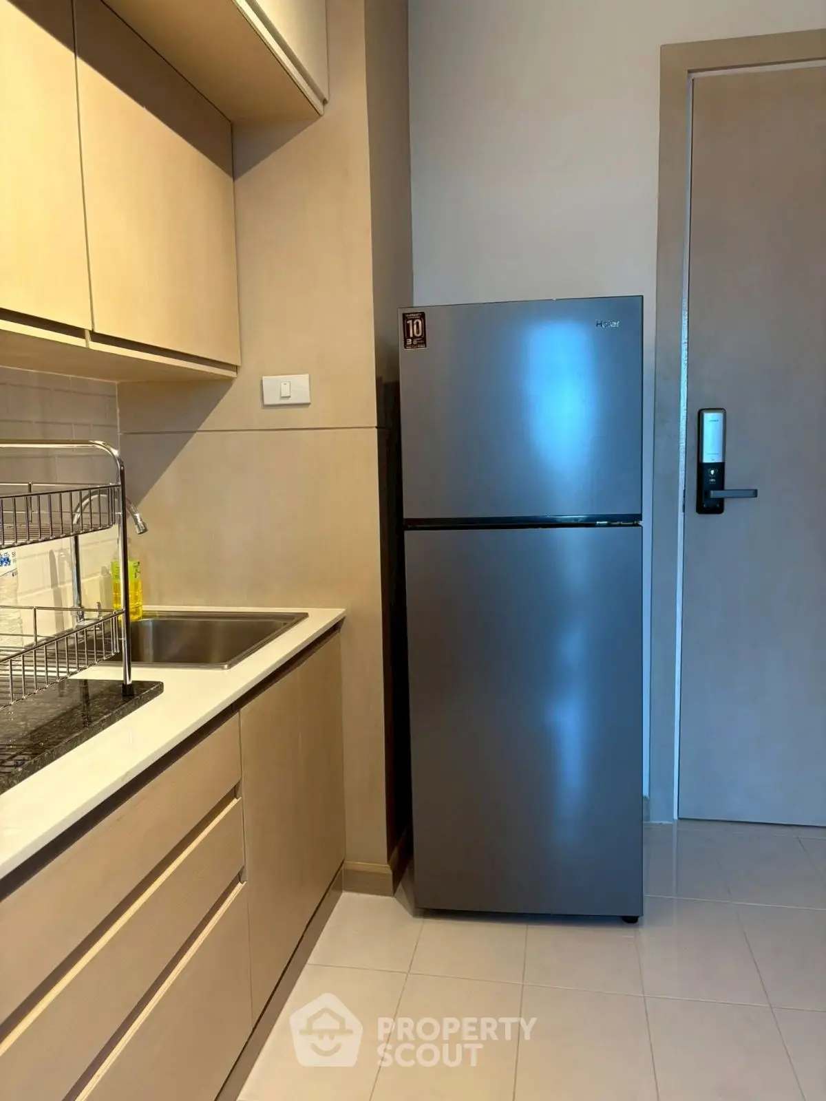 Modern kitchen with sleek fridge and wooden cabinetry