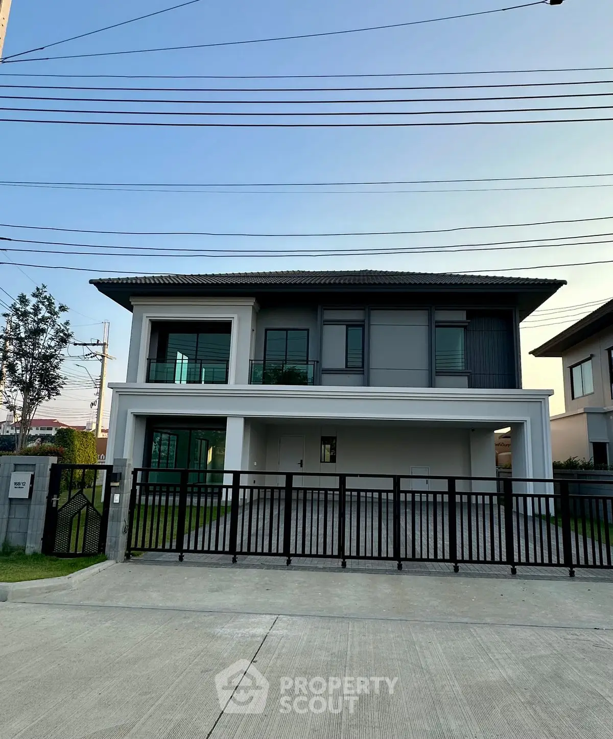 Modern two-story house with sleek design and spacious driveway