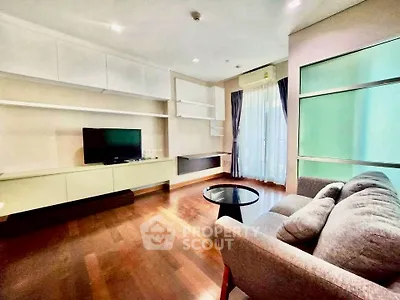 Spacious modern living room with hardwood floors and natural light