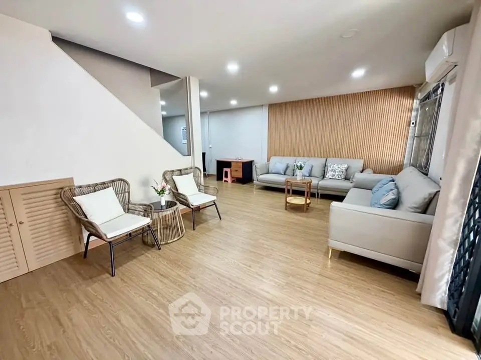 Spacious modern living room with stylish decor and wooden flooring