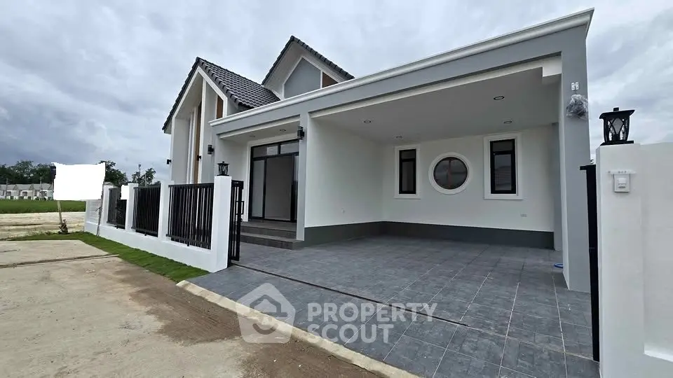 Modern single-story house with spacious driveway and contemporary design.