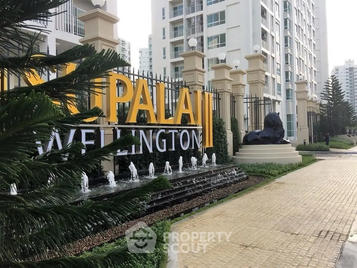 Luxurious apartment entrance with elegant signage and water feature at Palai Wellington.