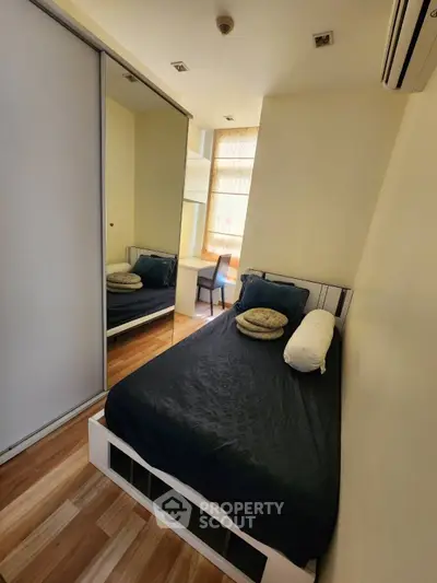 Cozy bedroom with mirrored wardrobe and natural light