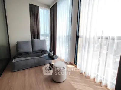 Bright modern living room with large windows and cozy seating area