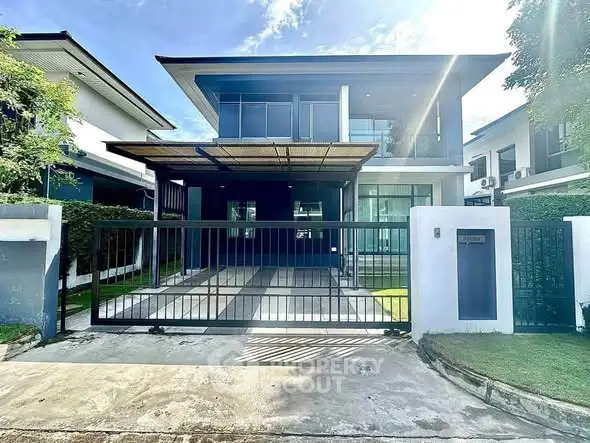 Modern two-story house with sleek design and spacious driveway in a serene neighborhood.