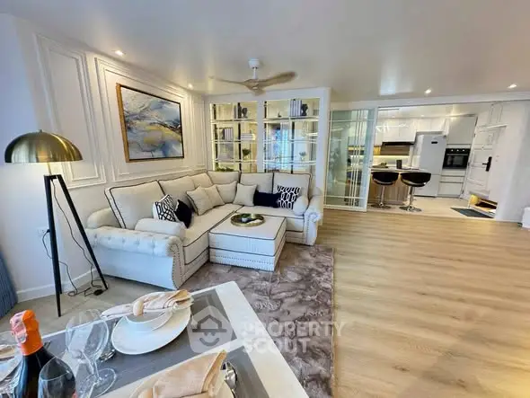 Luxurious open-plan living room with elegant decor and modern kitchen