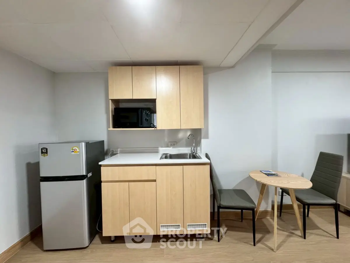 Compact kitchen with modern appliances and cozy dining area