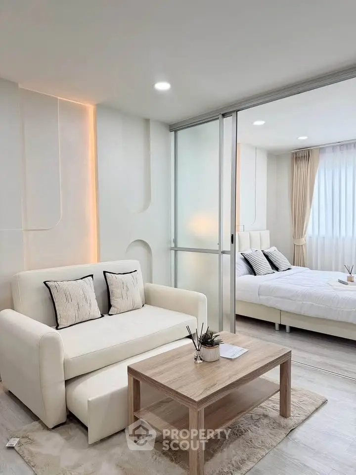 Modern living room with elegant decor and cozy bedroom view
