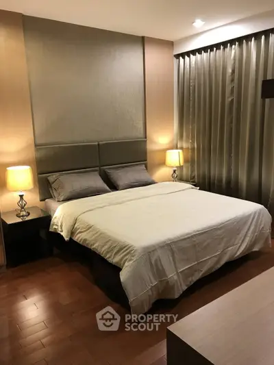 Luxurious bedroom with elegant lighting and modern decor, featuring a comfortable bed and stylish curtains.