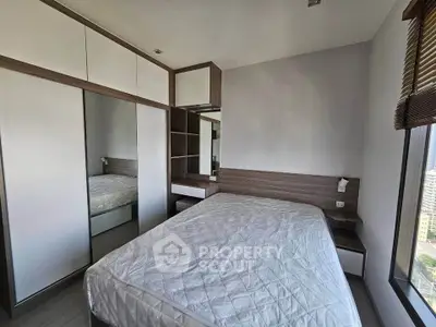 Modern bedroom with built-in wardrobe and city view, perfect for urban living.