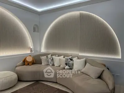 Modern living room with stylish curved sofa and ambient lighting