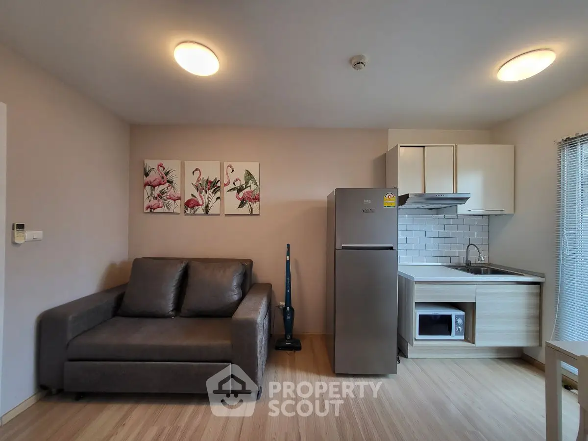 Modern studio apartment with cozy living area and compact kitchen
