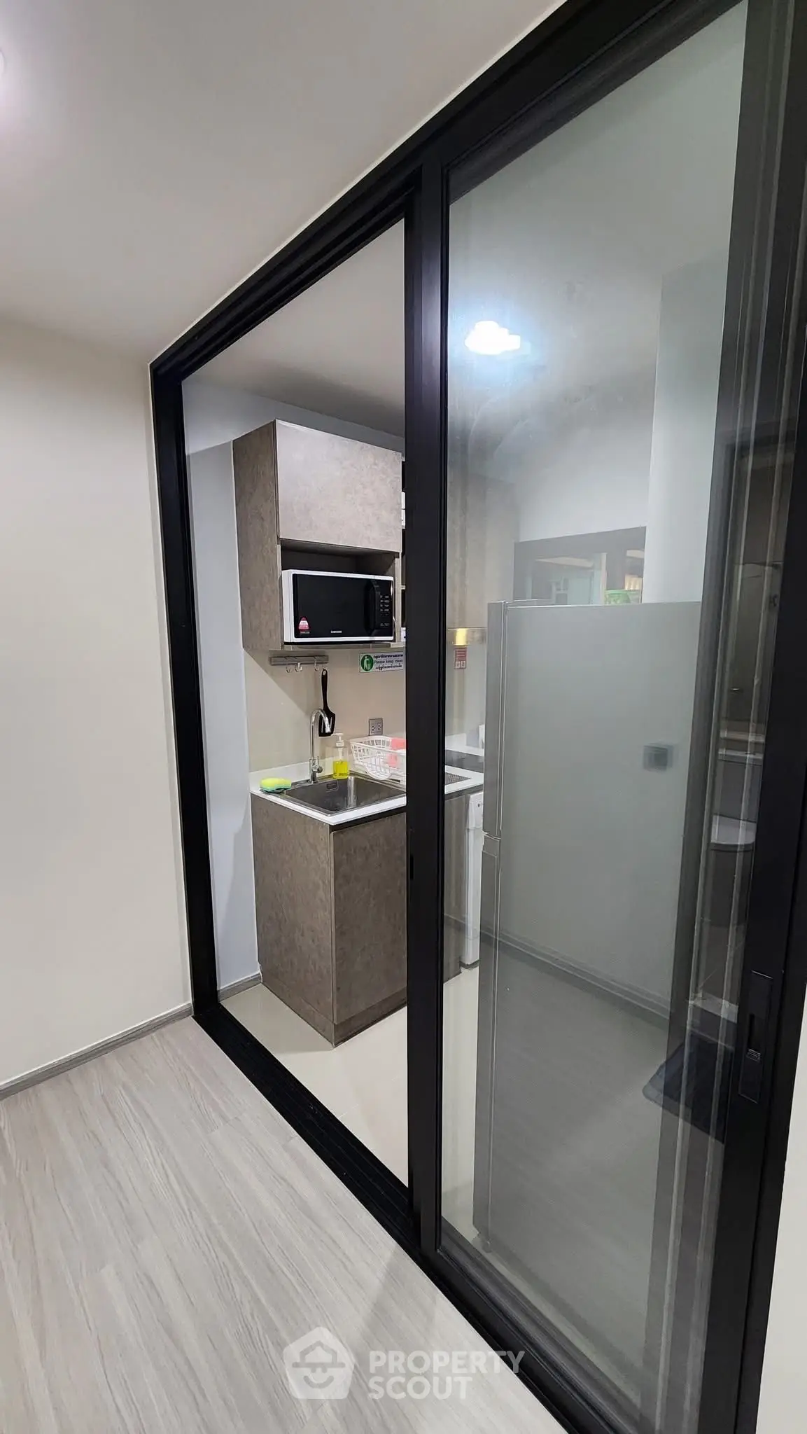 Modern compact kitchen with sleek design and built-in microwave