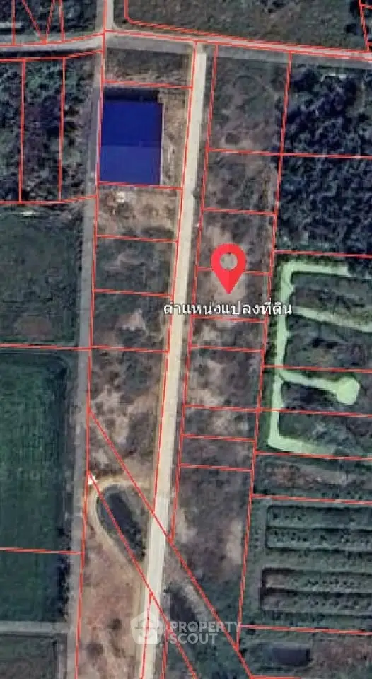 Aerial view of land plot with marked boundaries and location pin.
