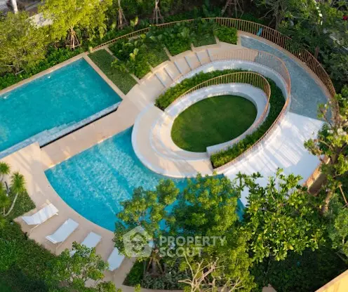 Luxurious aerial view of modern swimming pool with lush greenery and sun loungers