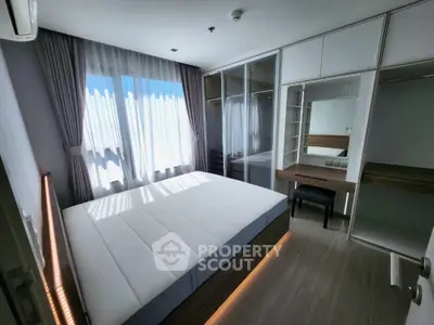 Modern bedroom with large window and built-in wardrobe