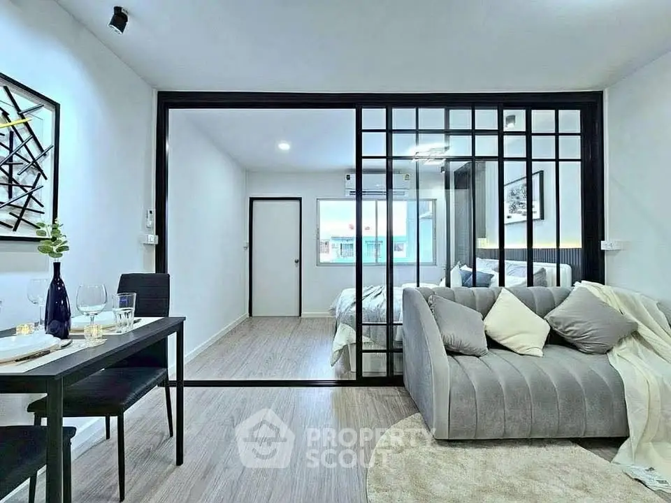 Modern open-plan living room with stylish decor and sliding glass doors