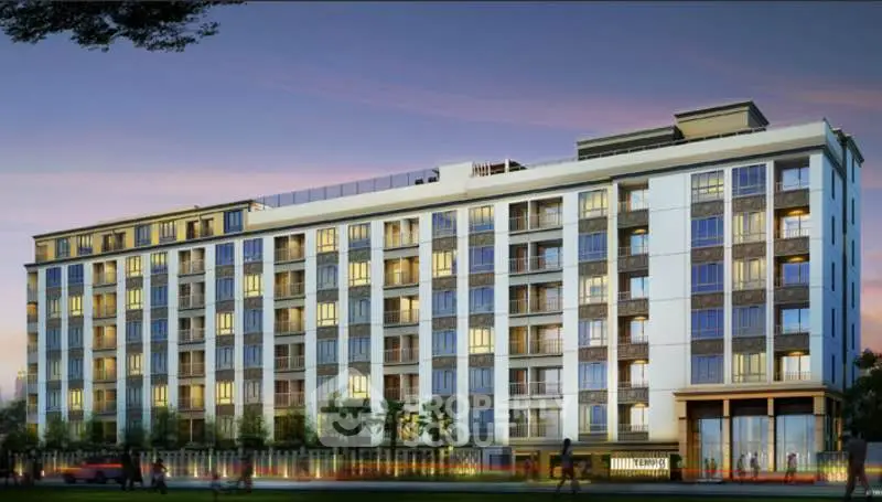 Modern multi-story residential building with illuminated windows at dusk, showcasing urban living.