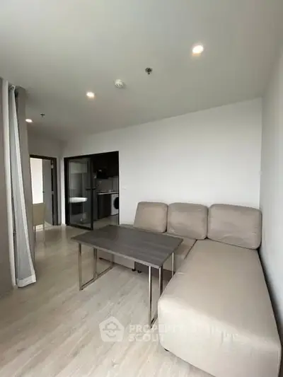 Modern living room with beige sofa and sleek table in a bright apartment