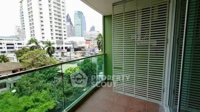 Spacious balcony with city view in modern apartment building