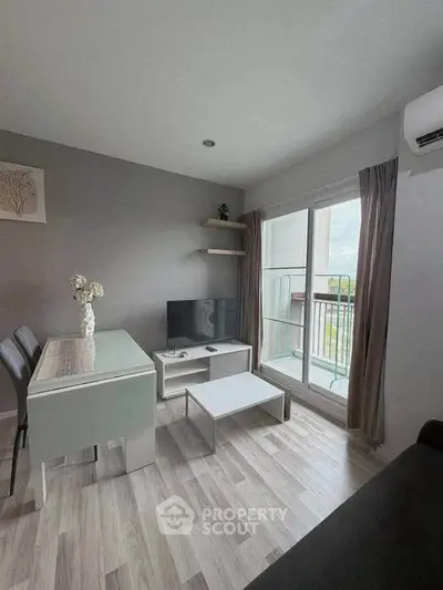 Modern living room with sleek furniture and balcony view