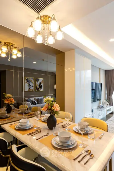 Luxurious dining area with elegant table setting and modern lighting in a stylish apartment.
