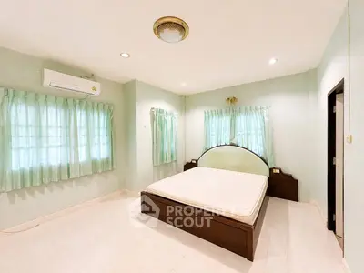 Spacious bedroom with natural light and minimalist design