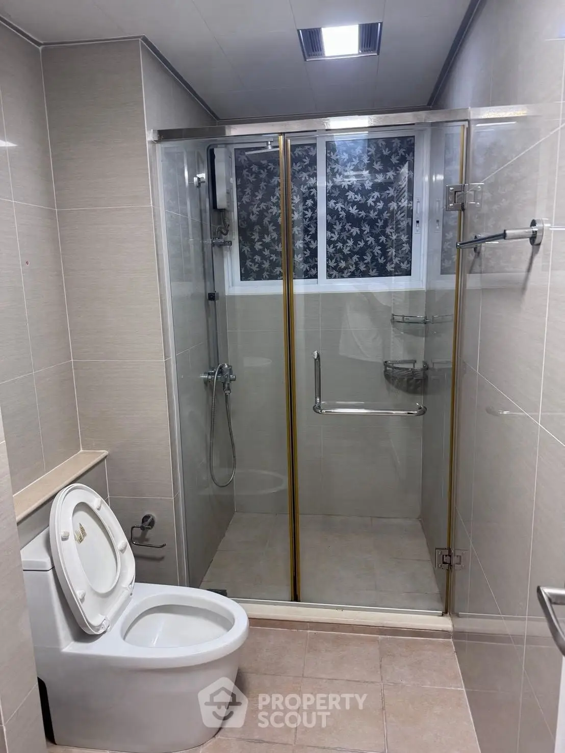 Modern bathroom with glass shower enclosure and sleek toilet design