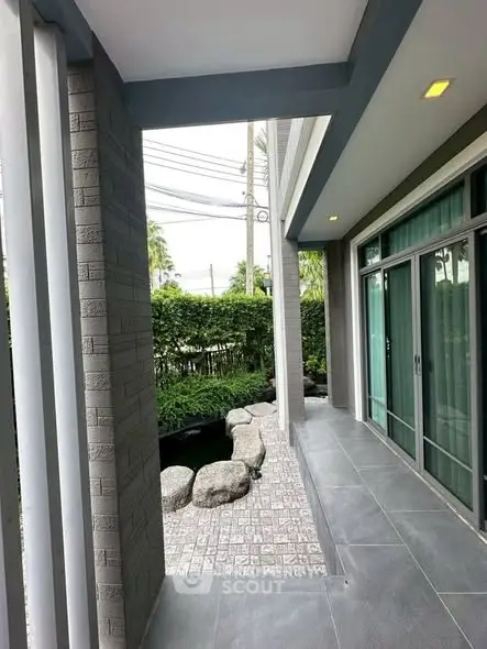 Modern home exterior with sleek design and lush garden view