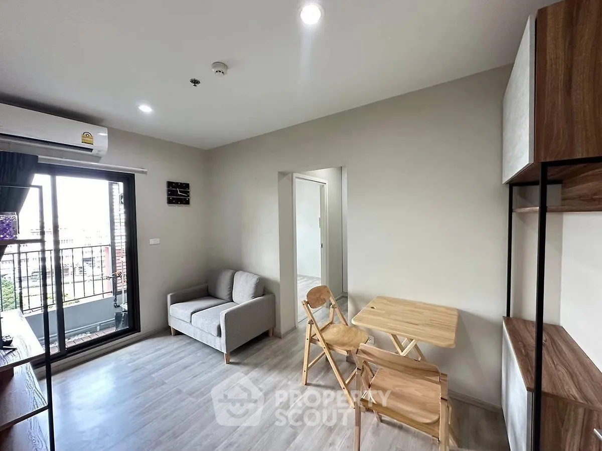 Modern living room with balcony access and stylish furniture