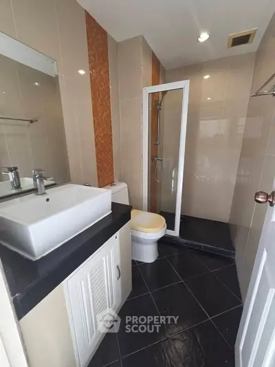 Modern bathroom with sleek fixtures and glass shower enclosure