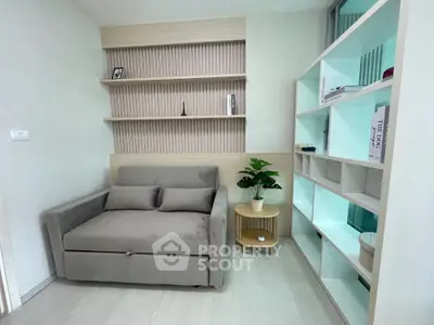 Modern living room with stylish sofa and built-in shelves, perfect for cozy relaxation.