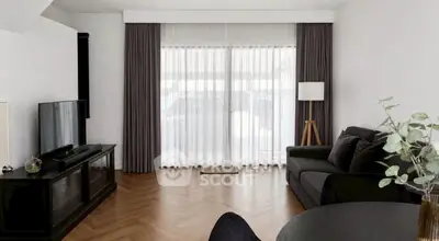 Spacious living room with elegant curtains and modern furniture, perfect for relaxation and entertainment.