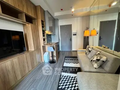 Modern living room with stylish decor and open kitchen layout in a cozy apartment.