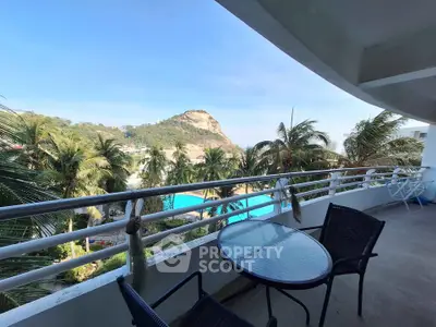 Stunning balcony view with tropical landscape and pool, perfect for relaxation and leisure.