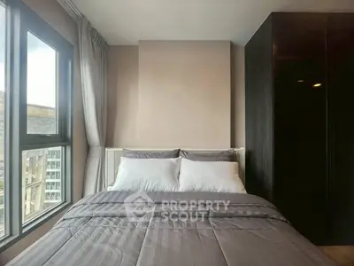 Modern bedroom with large window and sleek design in urban apartment