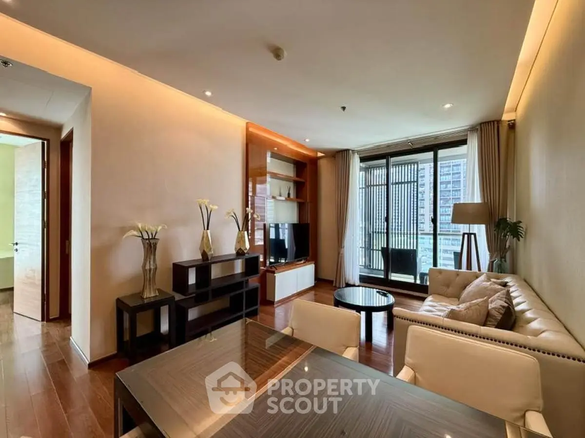 Luxurious living room with elegant decor and city view balcony.