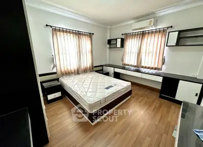 Spacious bedroom with modern furnishings and natural light