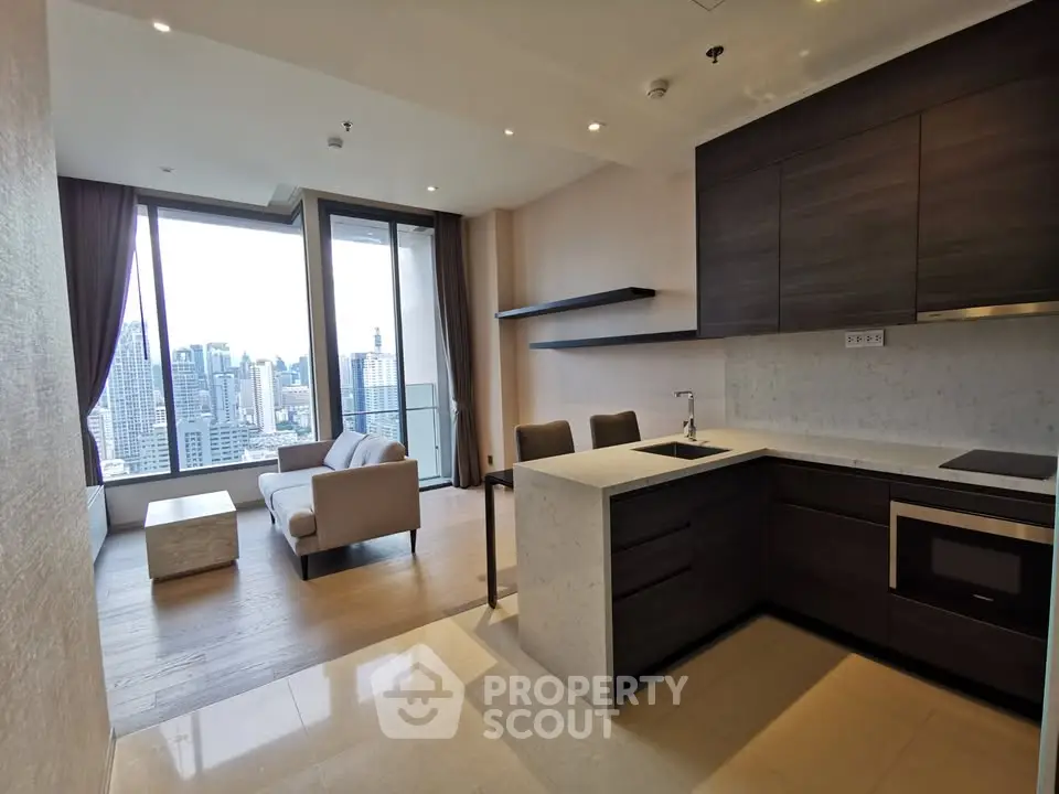 Modern open-plan kitchen and living room with city view in luxury apartment.